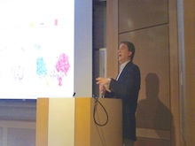 Dr. Lee Kraus speaking at a podium.