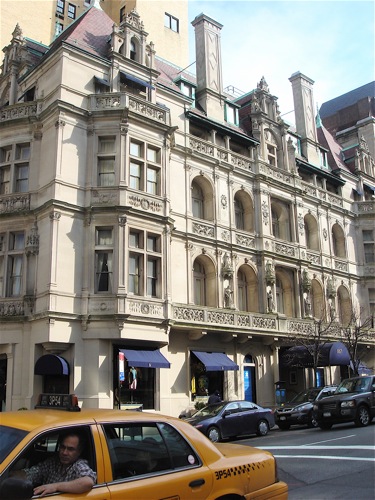 View of building and yellow taxi.