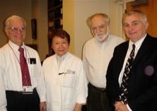 faculty standing together in conference room.