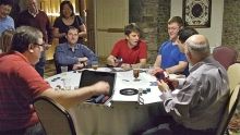 Students playing cards at a table.