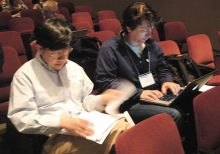 Students sitting in auditorium.