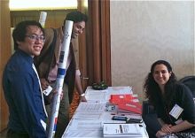 Students at table during symposium.