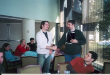 Students shaking hands in atrium.