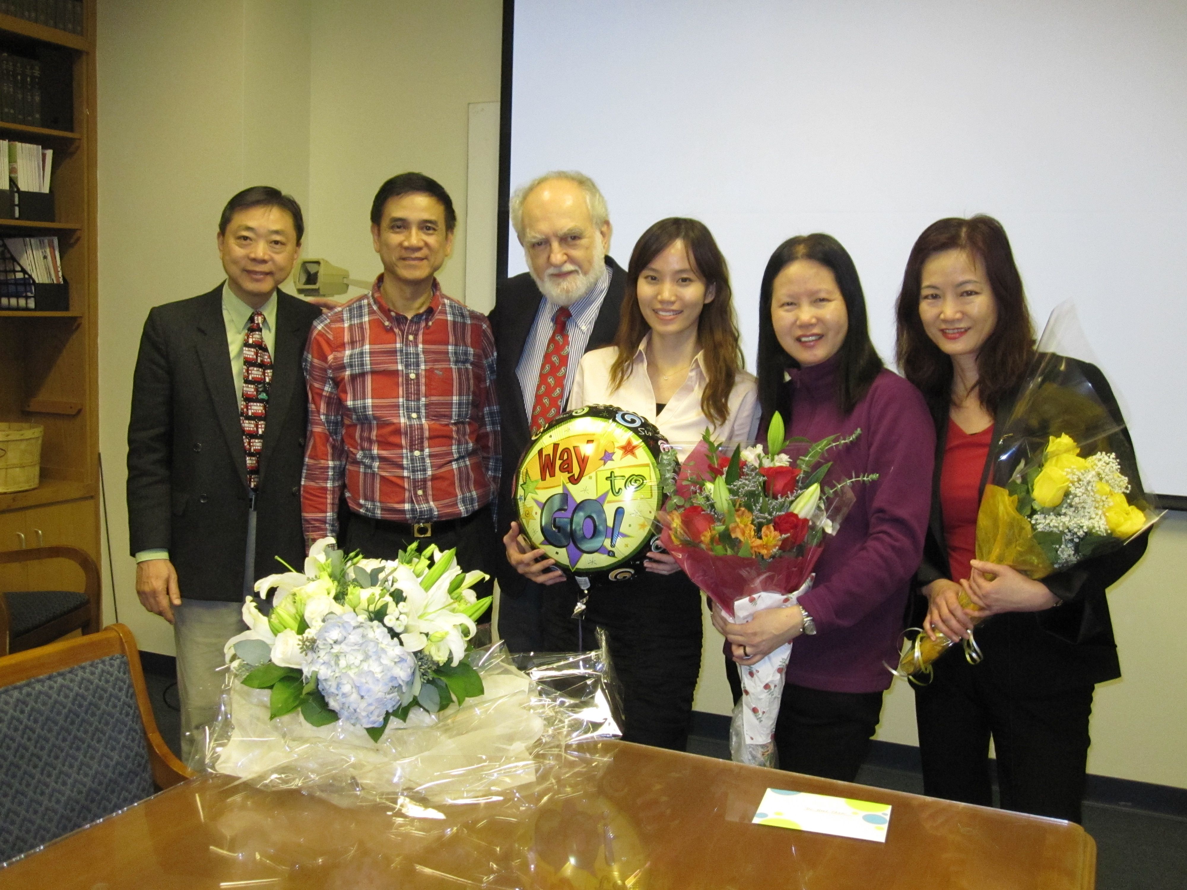 Chan with flowers and family at her defense.