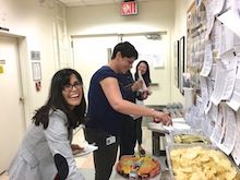 Group picking up food from the buffet.