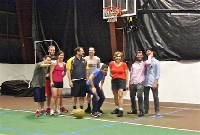 Students standing under a basketball hoop.