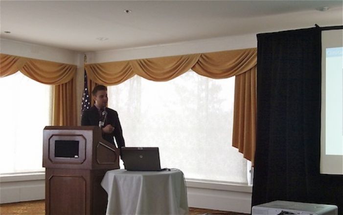 Presenter speaking at a podium.