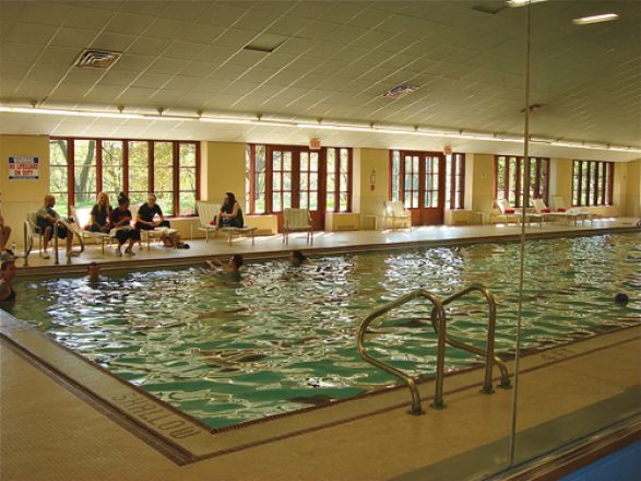 Students sitting near swimming pool. Students sitting near swimming pool.