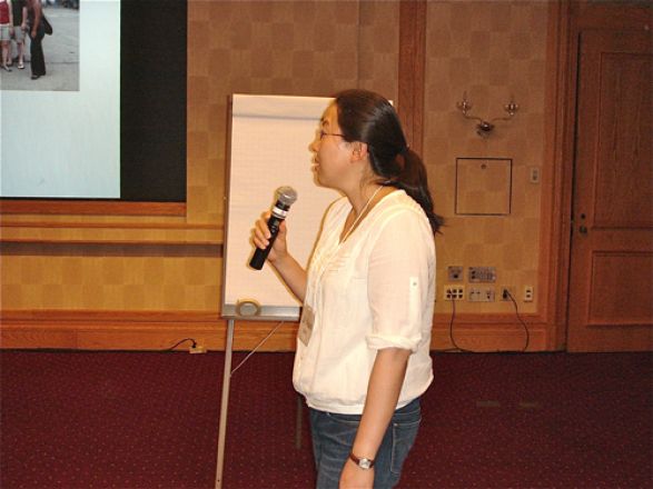 Woman presenting with a microphone.