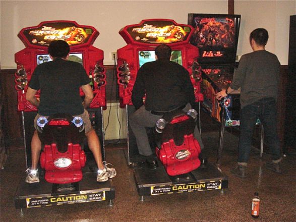 Students playing arcade games. Students playing arcade games.