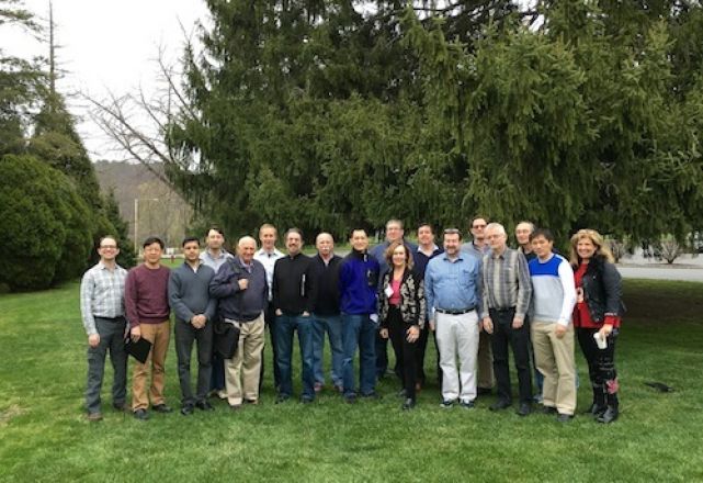 Faculty group standing outdoors.