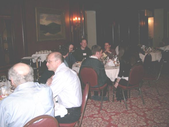 Attendees sitting at dining room table.