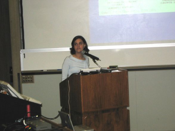 Researcher at podium during presentation.
