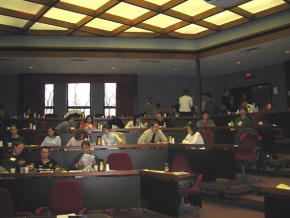 Attendees listen to a talk during the symposium. Attendees listen to a talk during the symposium.