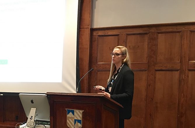 Researcher at podium during presentation. Researcher at podium during presentation.