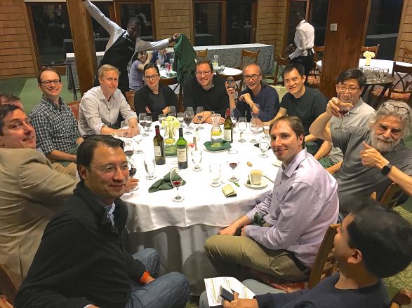 Group sitting around dining table. Group sitting around dining table.