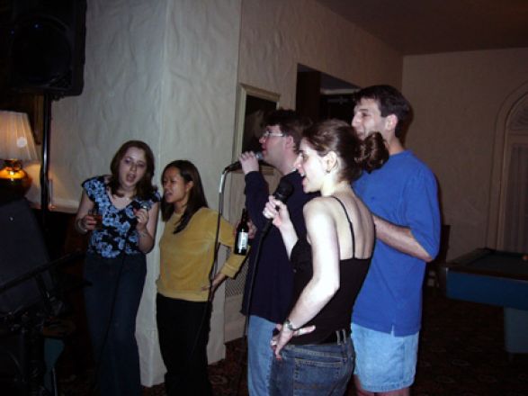 Students at microphone at party.