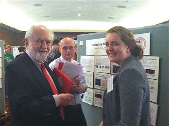 Student stands in front of presentation.