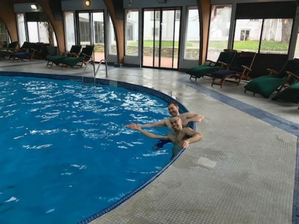 Jeet and Chris in a swimming pool.