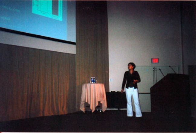 Student giving presentation on stage.