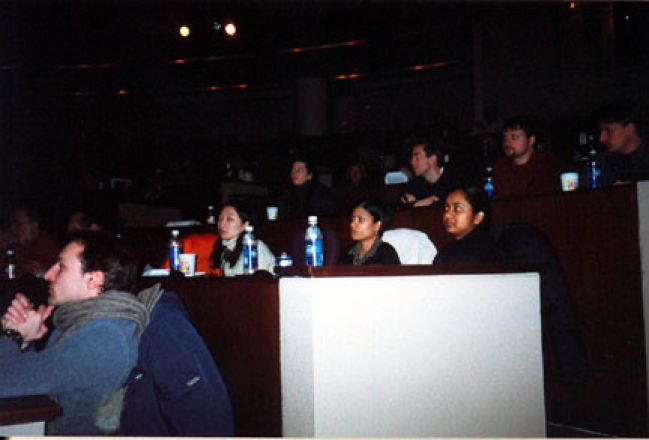 Students listening to presentation in auditorium.