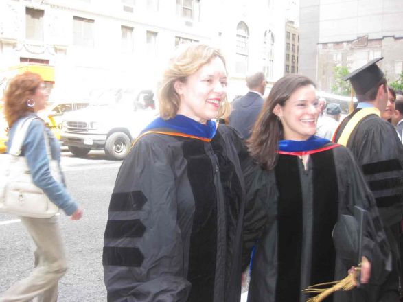 Dr. Gudas standing with graduate outside.