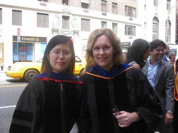 Dr. Gudas standing with graduate outside.