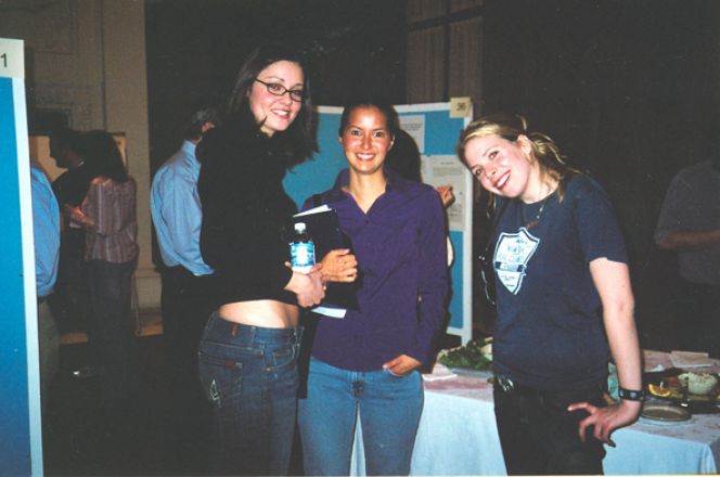 Students near a poster board.