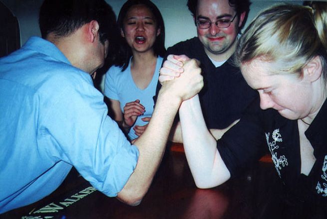 Students arm wrestling.