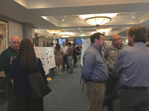 Scientists near their presentation boards. Scientists near their presentation boards.