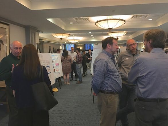 Scientists near their presentation boards.