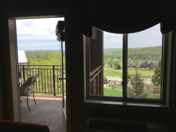 Hotel balcony overlooking a field.