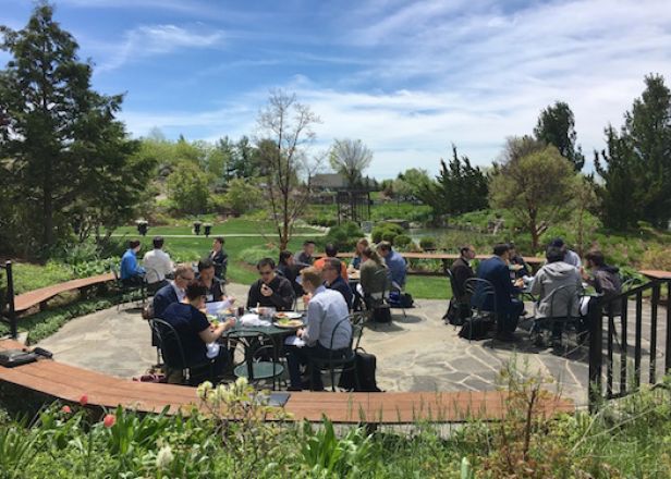 Group dining at tables outside.