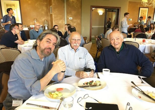 Colleagues at dining table during retreat.