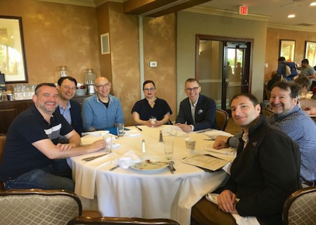 Colleagues at dining table during retreat.